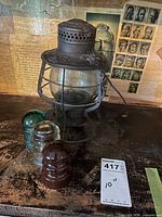 Lantern with three glass insulators and size reference tag