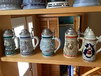 Five Avon Endangered Species steins on shelf