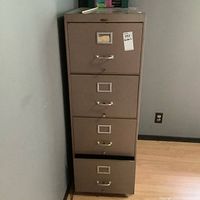 Front view of beige metal four-drawer filing cabinet