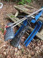 Steering sled leaning against steps with shovels visible