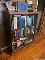Front view of bookcase showing sliding glass doors and shelves