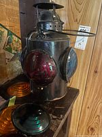 Lantern left side showing red lens and two loose amber/orange lenses
