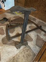 floor cobbler shoe stand, hand saw frame, extra shoe last visible