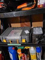 Shelf with grey toolbox, accessory bag and other items