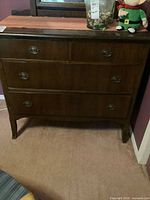Front view of dark brown 4-drawer dresser