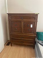 Full view of Dixie highboy chest next to bed