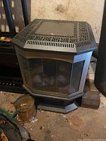 Full view of octagonal Dragon heater showing metal body, glass panels, top vent design