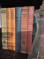 Six cloth-bound juvenile fiction spines including Bill Bolton titles, Secret Flight, Stand By, Circus Dan, The Tartan Pimpernel