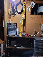 Pegboard wall with parts organizer, level, cords, hardware