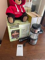 All items grouped: Firefly fire pot box, plush bear, lantern, flashlight, books