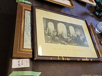 Both framed prints stacked on surface
