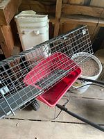 Broadcast spreader and trap cage together in storage area