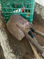 Wheelbarrow interior with crate and shovel