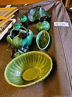 Group shot of all green glazed pottery pieces on table