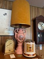 Group shot showing lamp, clock, canister, framed map