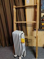 Heater standing in front of wooden rack showing both items together