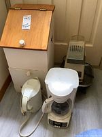 Appliances grouped in front of wood storage bin