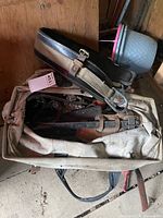 Canvas tote containing leather lineman belt, nylon strap and hardware