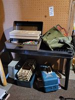 Overall view of tackle boxes and canvas bag on table