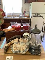 Group shot showing angel figurine, lantern, candles, bottle, box