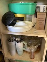 Overall lot on two shelves showing bowls, tumblers, glass bowl, utensil and boxed items