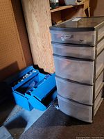 Plastic tower and blue toolbox side by side