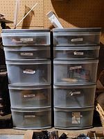 Front view of two stacked plastic drawer units with labels on drawers