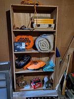 Front view of plywood bookcase with contents for scale