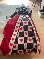 Front view of Queen of Hearts dress laid flat showing full design and colors
