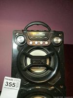 Front upper section of Sylvania SP328-B showing brand label, control knobs, top speaker driver