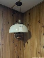 Full view of hanging pendant lamp showing milk glass shade, burner, chains
