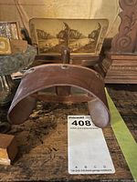 Front view showing stereoscope viewer, stereocard, glass compote, brass figurine and portion of beer stein