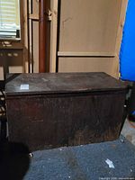 Full exterior view of dark brown plywood chest