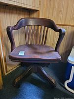 Front view showing overall form of wooden swivel chair