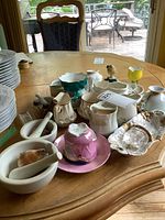 Overall view showing plates, mortar and pestles, assorted cups, figurine and trinket dish