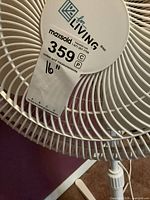 Front view of fan showing grille, brand label, condition