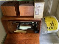 Overall view showing bread box, tissue boxes, boxed scale, utensils, foam plates