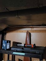 Binoculars box, flashlight, BBQ case on shelf