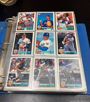 binder open showing nine baseball cards in sleeves