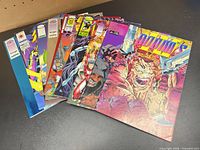 Fanned stack of all ten comics showing covers and publishers