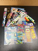 Stack of assorted Valiant and Image comic books, showing multiple titles and covers