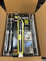 Front of packaged ATAK pocket tech light showing branding, 80 lumens spec and COB strip