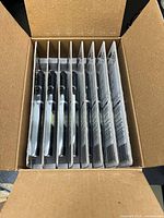 Open carton showing eight carded ATAK pen lights
