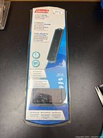 Front view of sealed Coleman 2W solar battery maintainer packaging