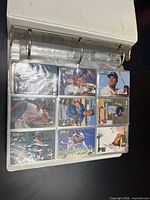 Binder front open showing nine sleeved cards