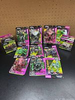 All 12 Final Faction items laid out: ten blister cards and one boxed playset