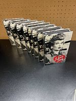 Angle view of eight sealed VHS tapes standing in a row
