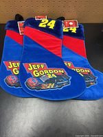 Front view of three Jeff Gordon #24 stockings showing graphics, tags, colours