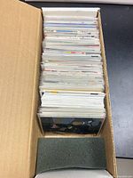 Top view of sleeved cards in single-row cardboard box