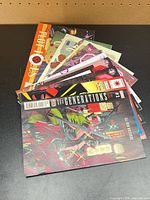 Stack of approximately 10 comic books, top issue Generations #1, visible Plot Holes, other assorted covers